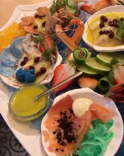 Seafood starters served in scallop shells with salmon and citrus