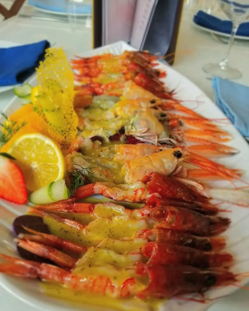 Red prawns with citrus sauce, lemon and strawberry